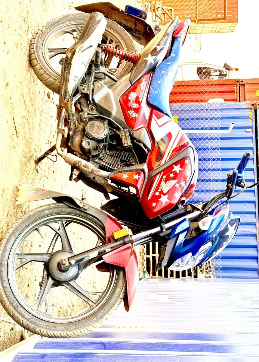 Moto Honda SP125, bien entretenue, rouge et bleu